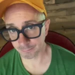 Steve Burns in a yellow hat and black rimmed glasses