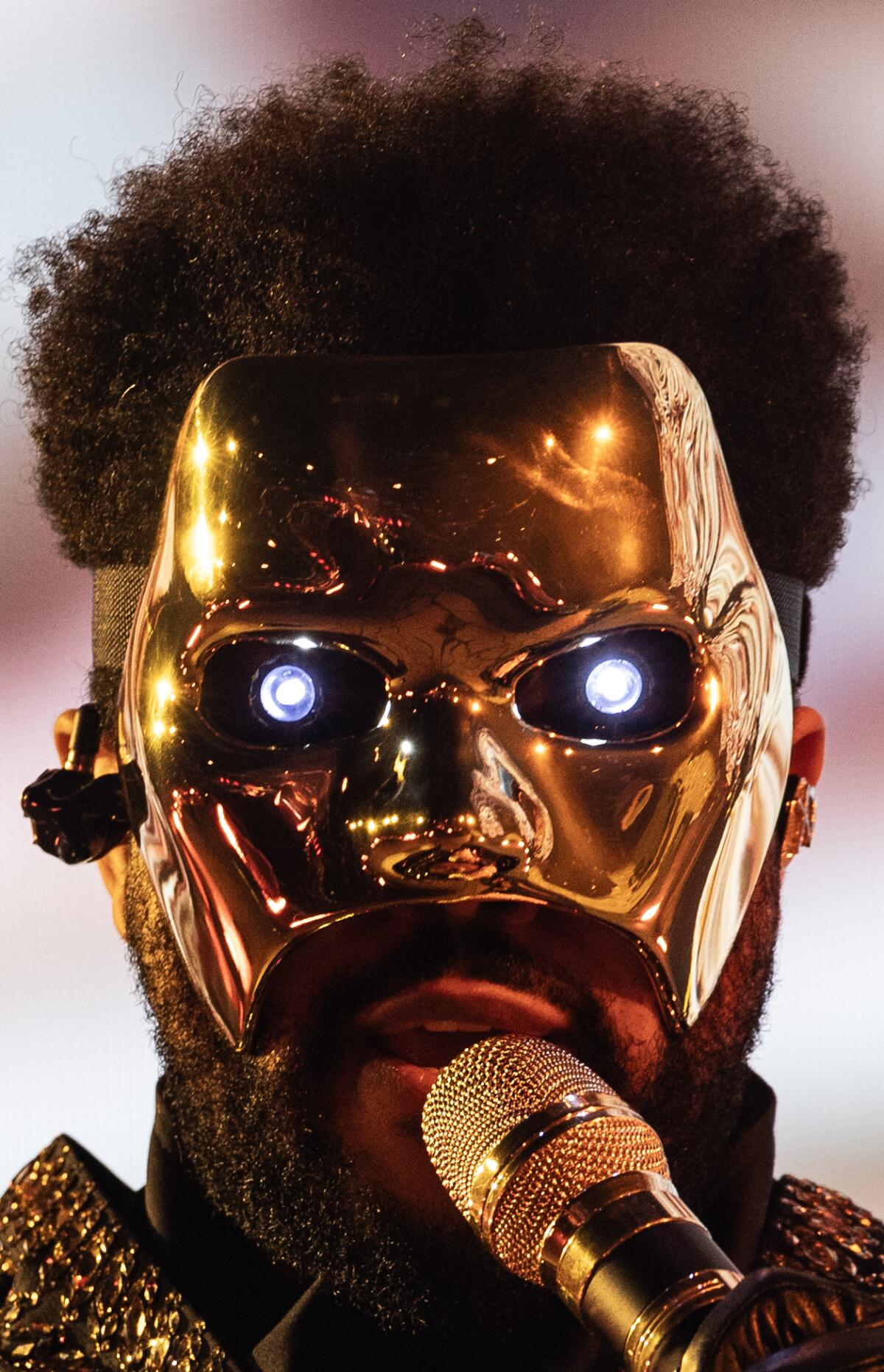 Man in a gold mask with glowing eyes