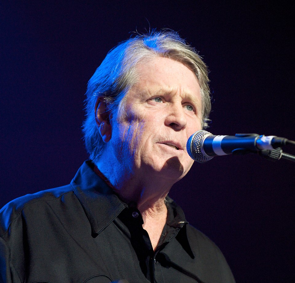 Brian Wilson of The Beach Boys singing into a microphone.