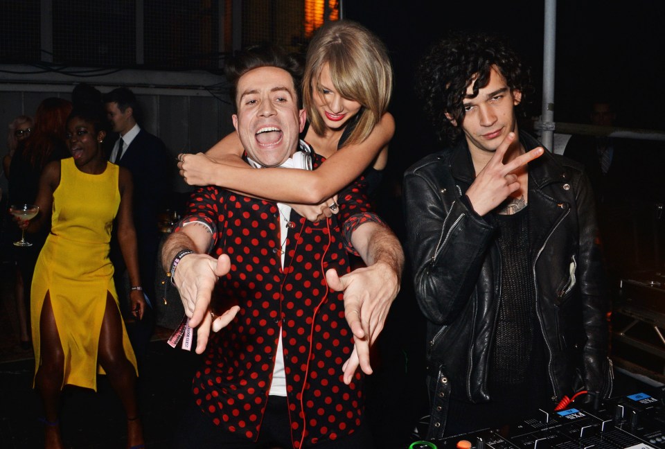 Taylor Swift with Nick Grimshaw and Matt Healy at a party.