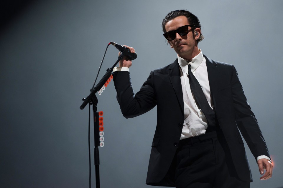 Matty Healy of The 1975 performing on stage.