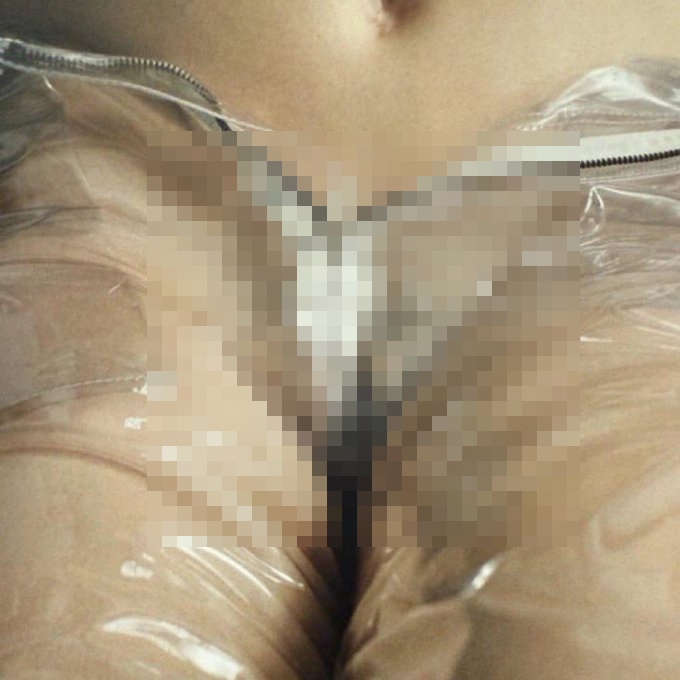 Close-up image of a woman's crotch, partially obscured.