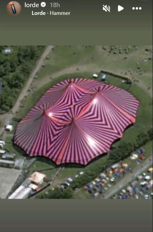 Aerial view of a large striped tent at Glastonbury Festival.