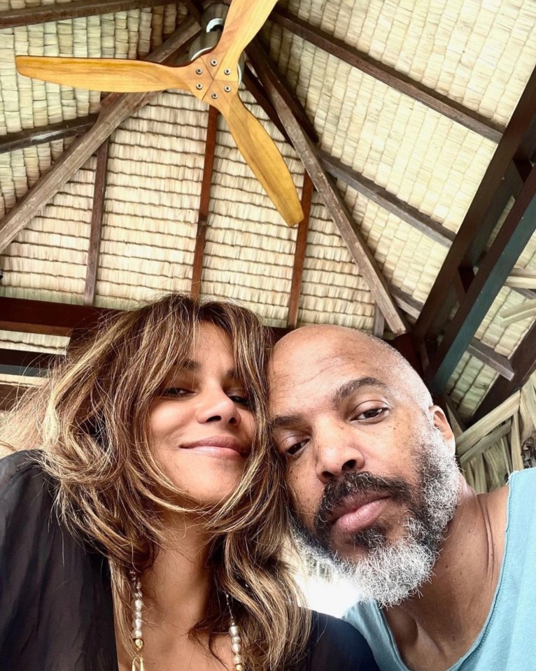 Halle Berry and Van Hunt cuddling.