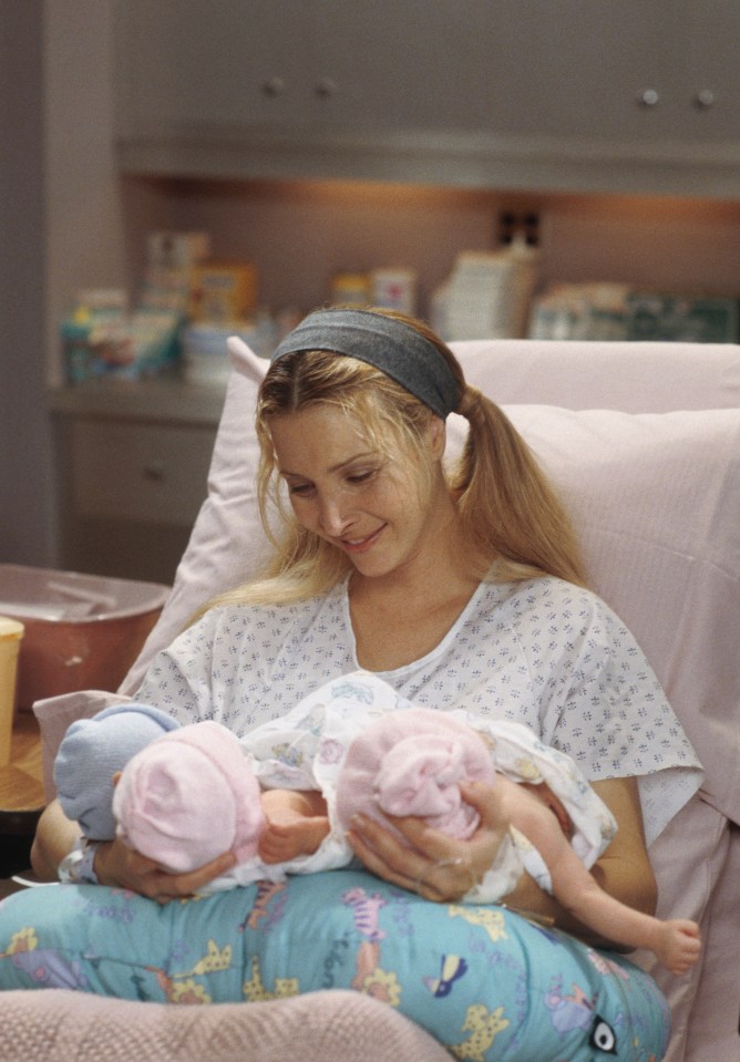 Lisa Kudrow as Phoebe Buffay holding twin babies in a hospital.
