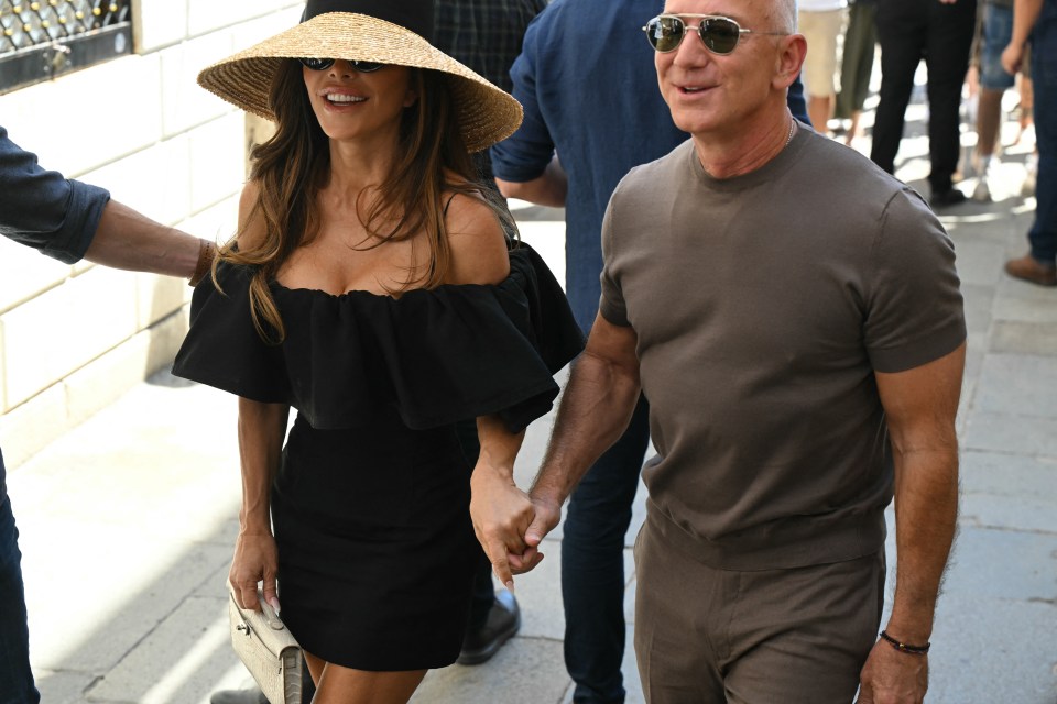 Jeff Bezos and Lauren Sanchez holding hands.