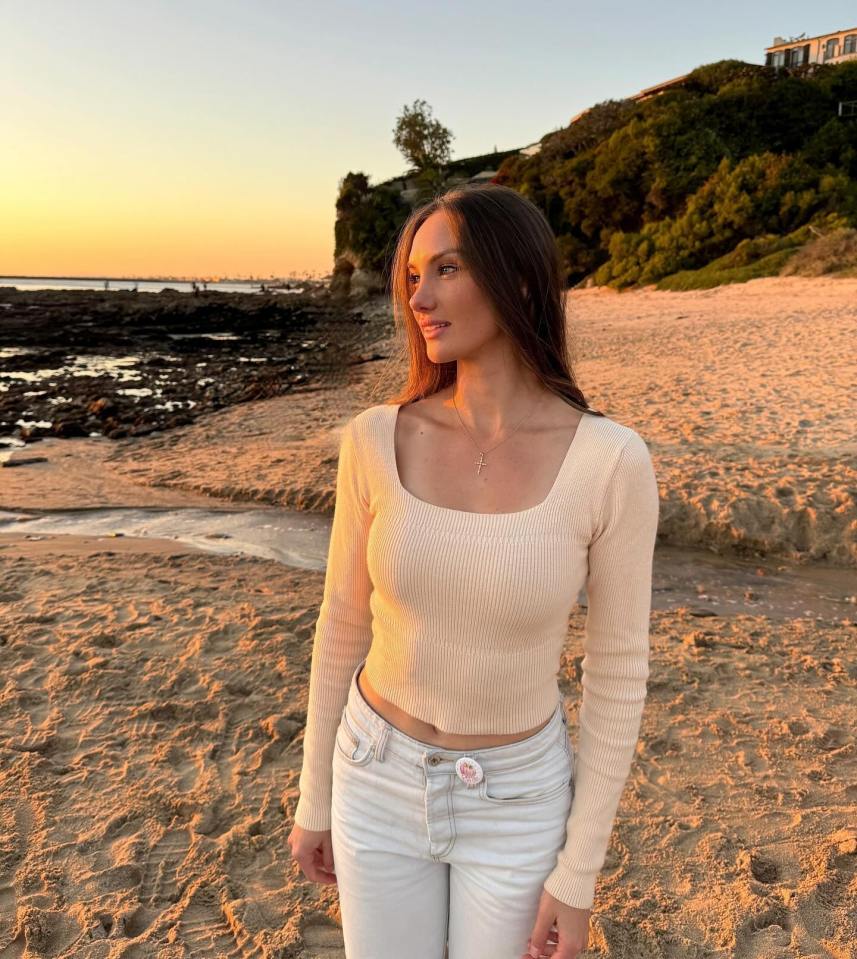 Woman on beach at sunset.