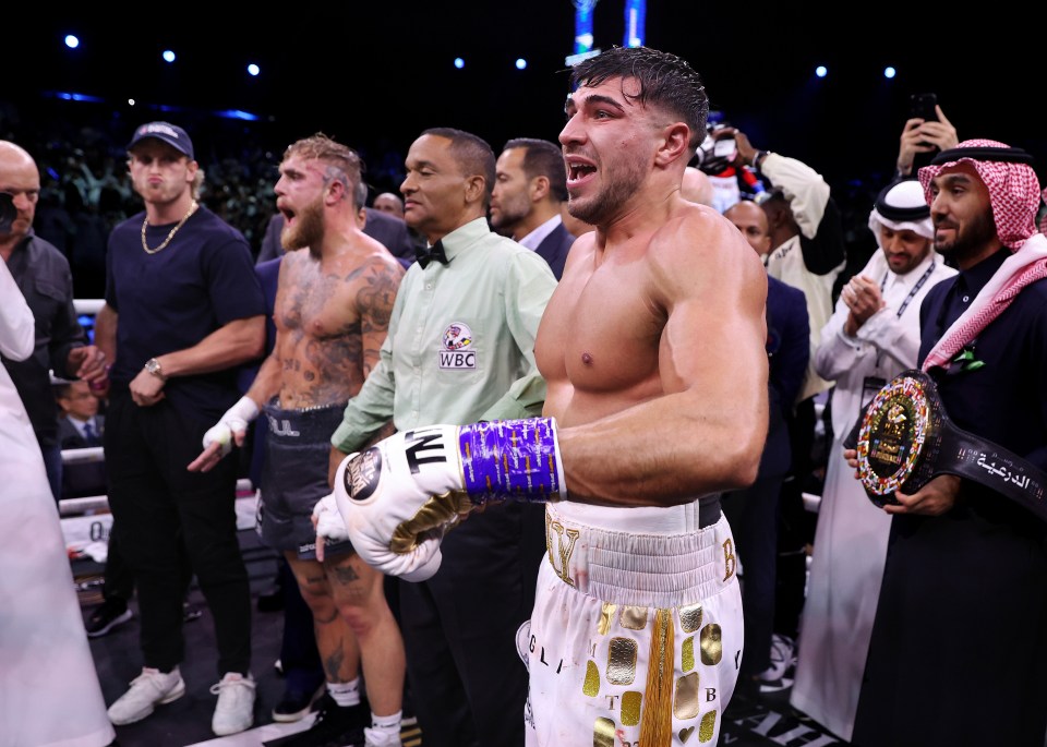 Tommy Fury celebrates his victory over Jake Paul in a boxing match.