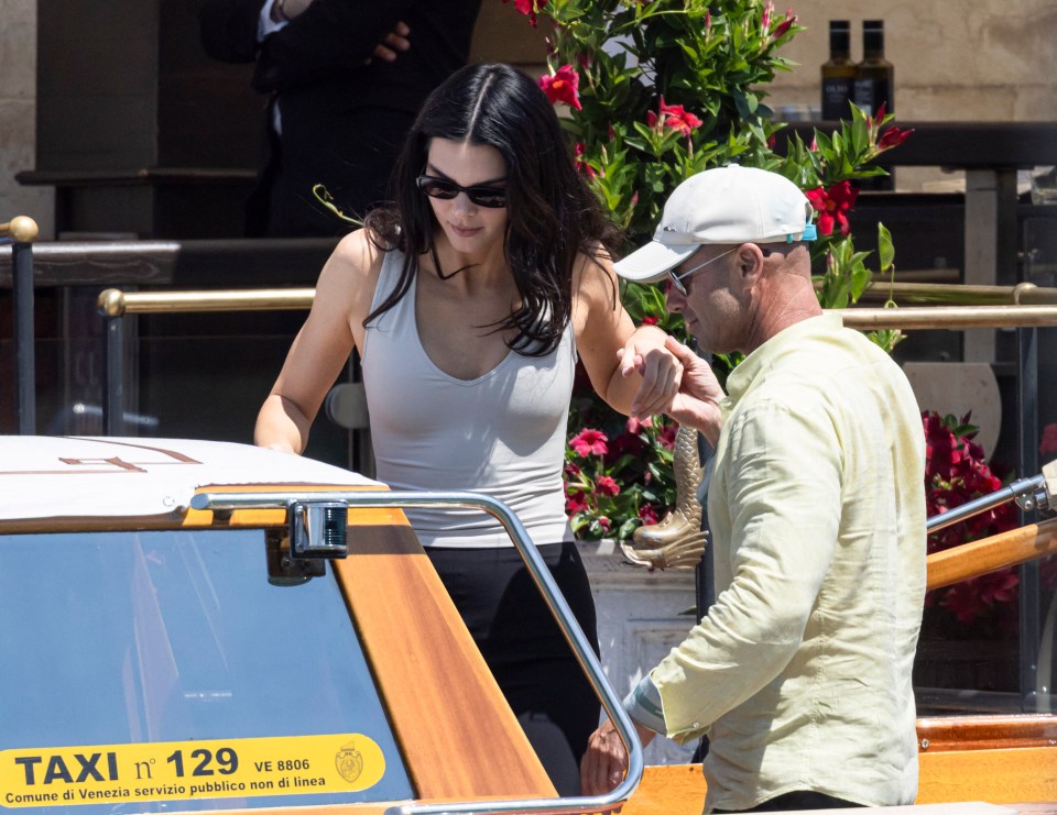 Kendall Jenner and a man boarding a water taxi.