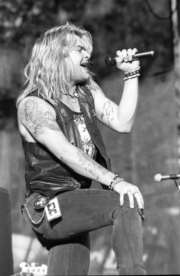 Black and white photo of David Roach performing on stage.