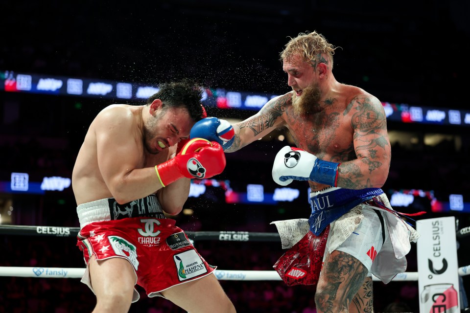 Jake Paul landing a punch on Julio Cesar Chavez Jr. during a boxing match.