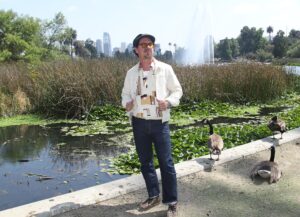 Musician Adrian Quesada poses for a picture at Echo Park Lake in Los Angeles on Sunday, May 18, 2025.