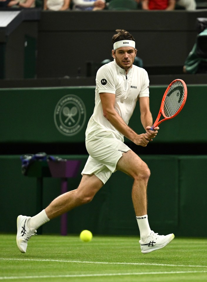 Taylor Fritz playing tennis at Wimbledon.