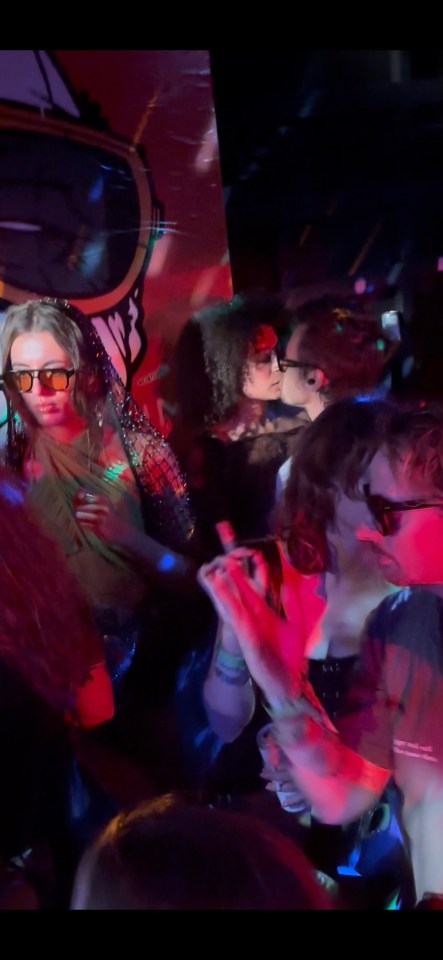 Harry Styles kissing a woman at a festival.