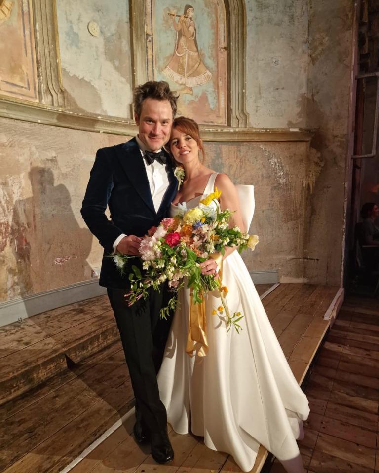 A bride and groom pose for a wedding photo.
