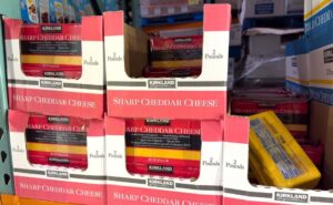 display of Kirkland sharp cheddar cheese at Costco
