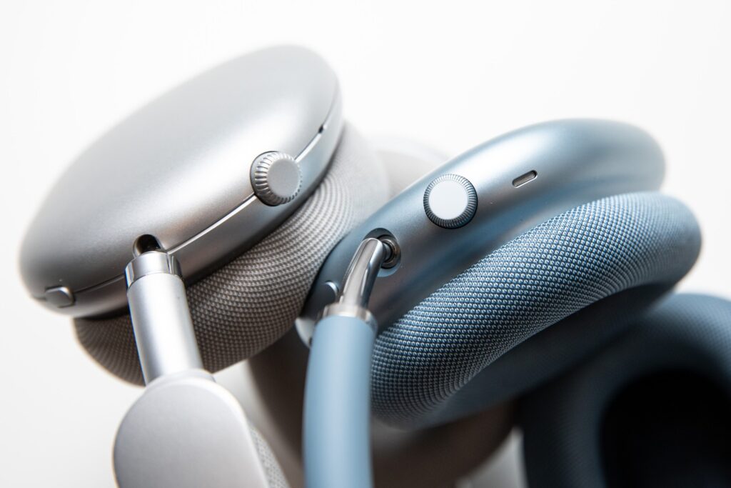 Close shots of the buttons on two sets of headphones.
