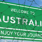 spider webs covering welcome to Australia sign