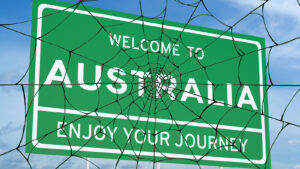 spider webs covering welcome to Australia sign