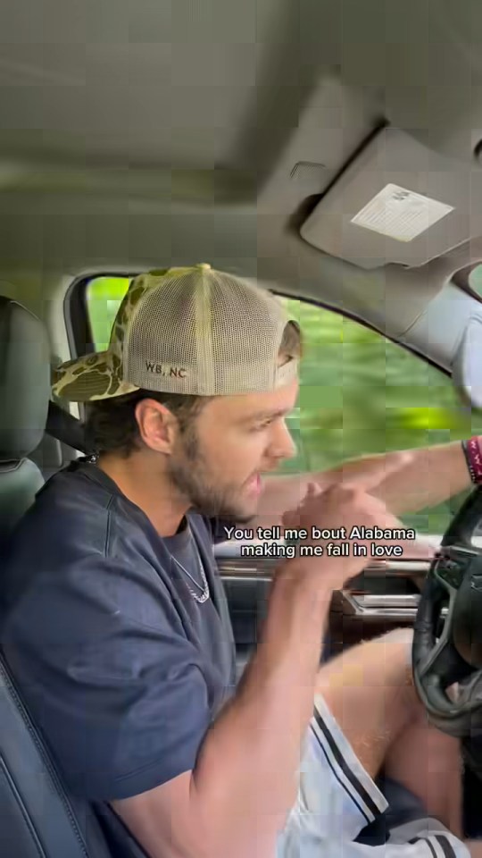 Man in a car singing about Alabama.