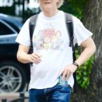Eric Stoltz wearing a Peanuts t-shirt and cap.