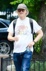 Eric Stoltz wearing a Peanuts t-shirt and cap.