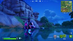 A Fortnite screenshot depicting Lewis Hamilton waiting through west deep water at the bottom of a gorge.