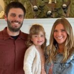 Family portrait in front of a fireplace.