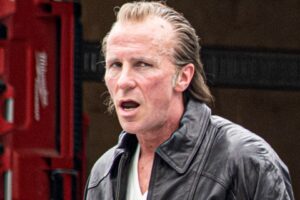 Christian Bale on the set of "Madden," wearing a leather jacket.