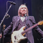 Tom Petty with his guitar on stage