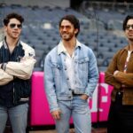 The Jonas Brothers at a baseball game.