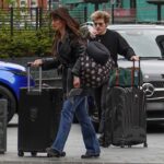 Aimee Osbourne and Wes Leavins leaving a hotel with luggage.