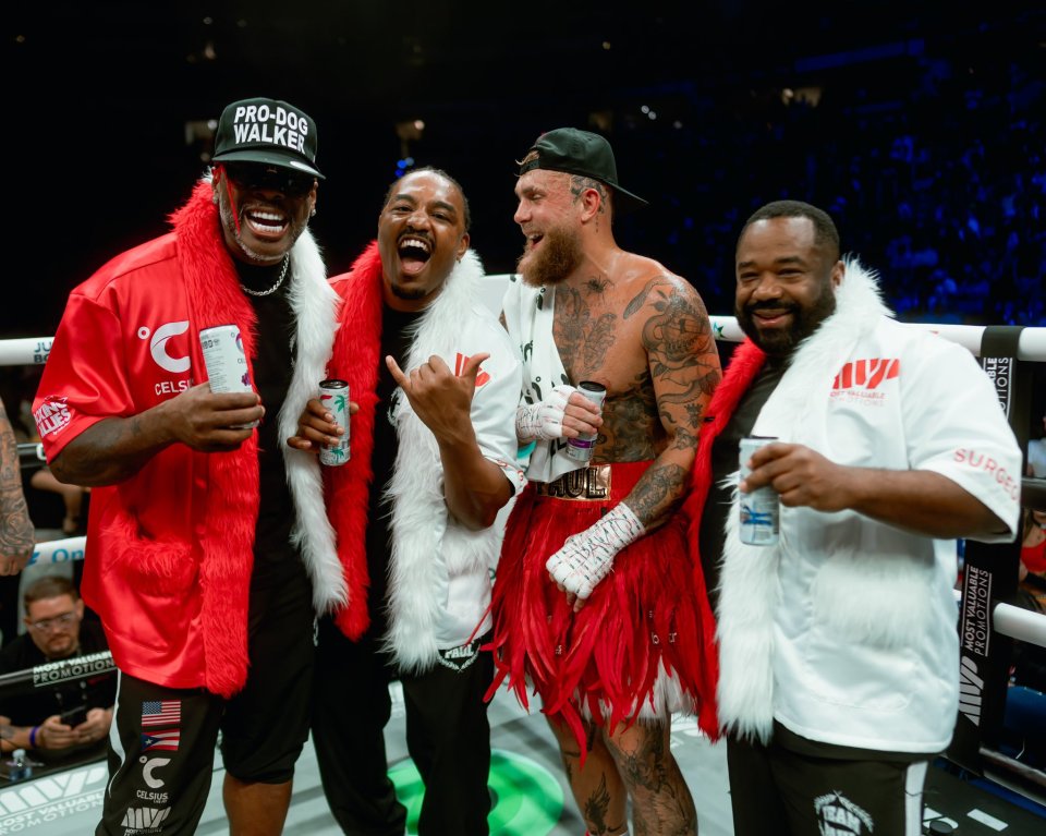 Boxers and their teams celebrating after a boxing match.