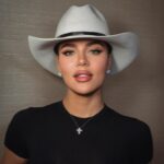 Khloe Kardashian wearing a cowboy hat and black shirt.