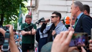 Crowds greet Kneecap rapper facing terrorism charge outside court – video