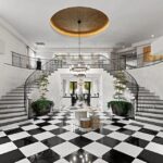 Rob Kardashian's Hidden Hills mansion entryway with double staircases and a checkerboard floor.