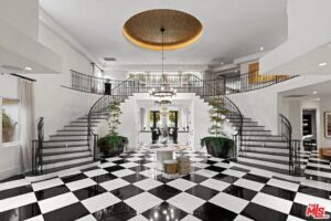 Rob Kardashian's Hidden Hills mansion entryway with double staircases and a checkerboard floor.