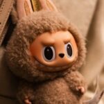 A photo of a Labubu dolls in someone's handbag.