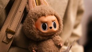 A photo of a Labubu dolls in someone's handbag.