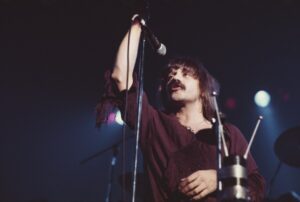 Terry Luttrell of Starcastle performing live on stage.