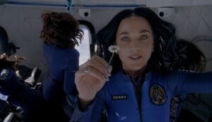 Katy Perry holding a daisy while experiencing zero gravity on a Blue Origin space flight.