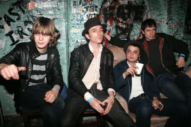 A photo of four men sitting together.