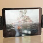 An image showing the iPad Air equipped with the Razer Kishi V3 Pro XL. The iPad is displaying the game Expedition 33: Clair Obscur.