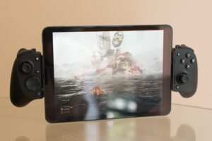 An image showing the iPad Air equipped with the Razer Kishi V3 Pro XL. The iPad is displaying the game Expedition 33: Clair Obscur.
