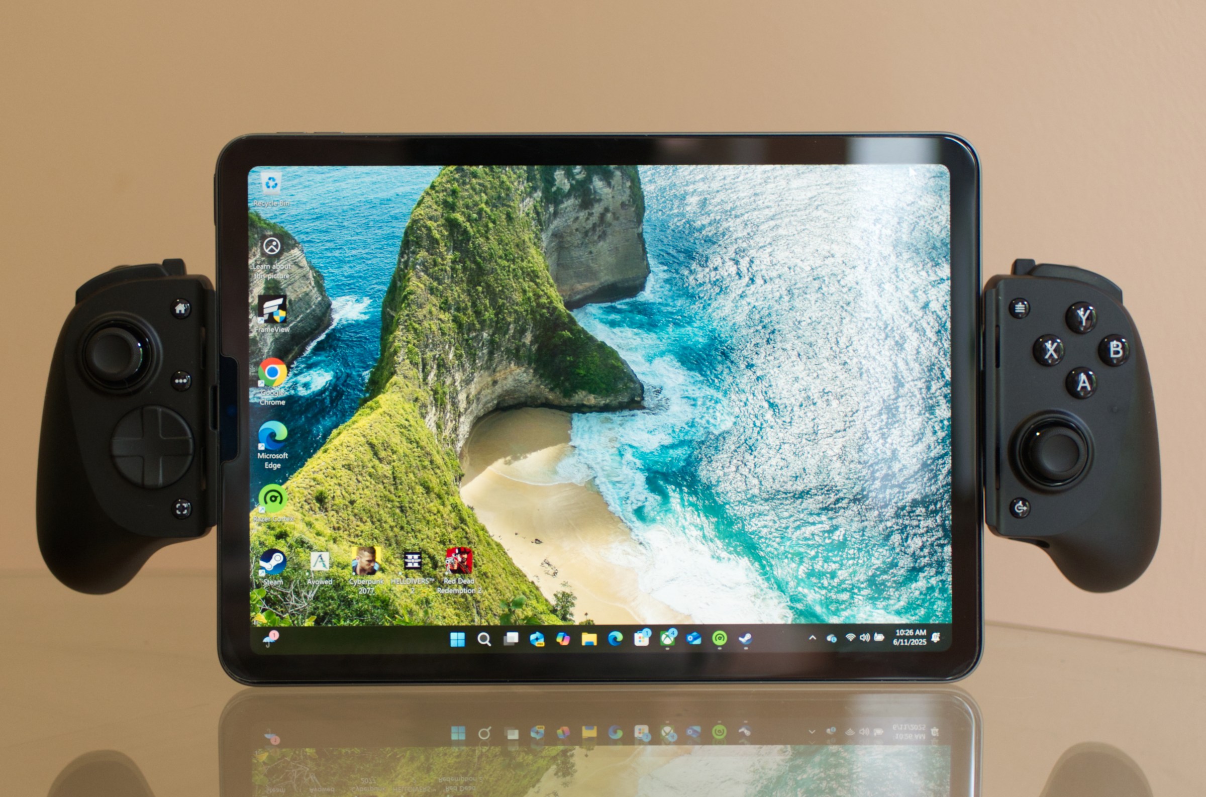An image showing an iPad Air equipped with the Razer Kishi V3 Pro XL game controller. The iPad is displaying a Windows 11 homescreen.