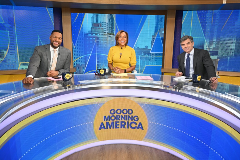 Photo of Michael Strahan, Robin Roberts, and George Stephanopoulos on the set of Good Morning America.