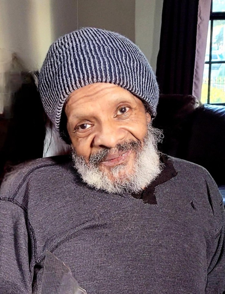 Portrait of a smiling man wearing a knit cap.