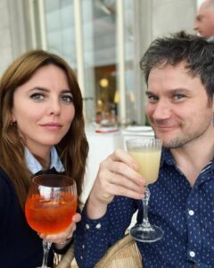 A man and woman holding cocktails.