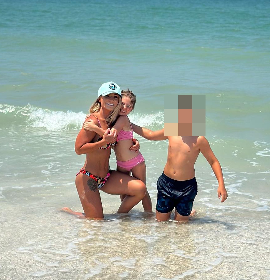 Woman and two children at the beach.