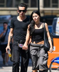 Matt Healy and Gabbriette Bechtel holding hands in New York City.